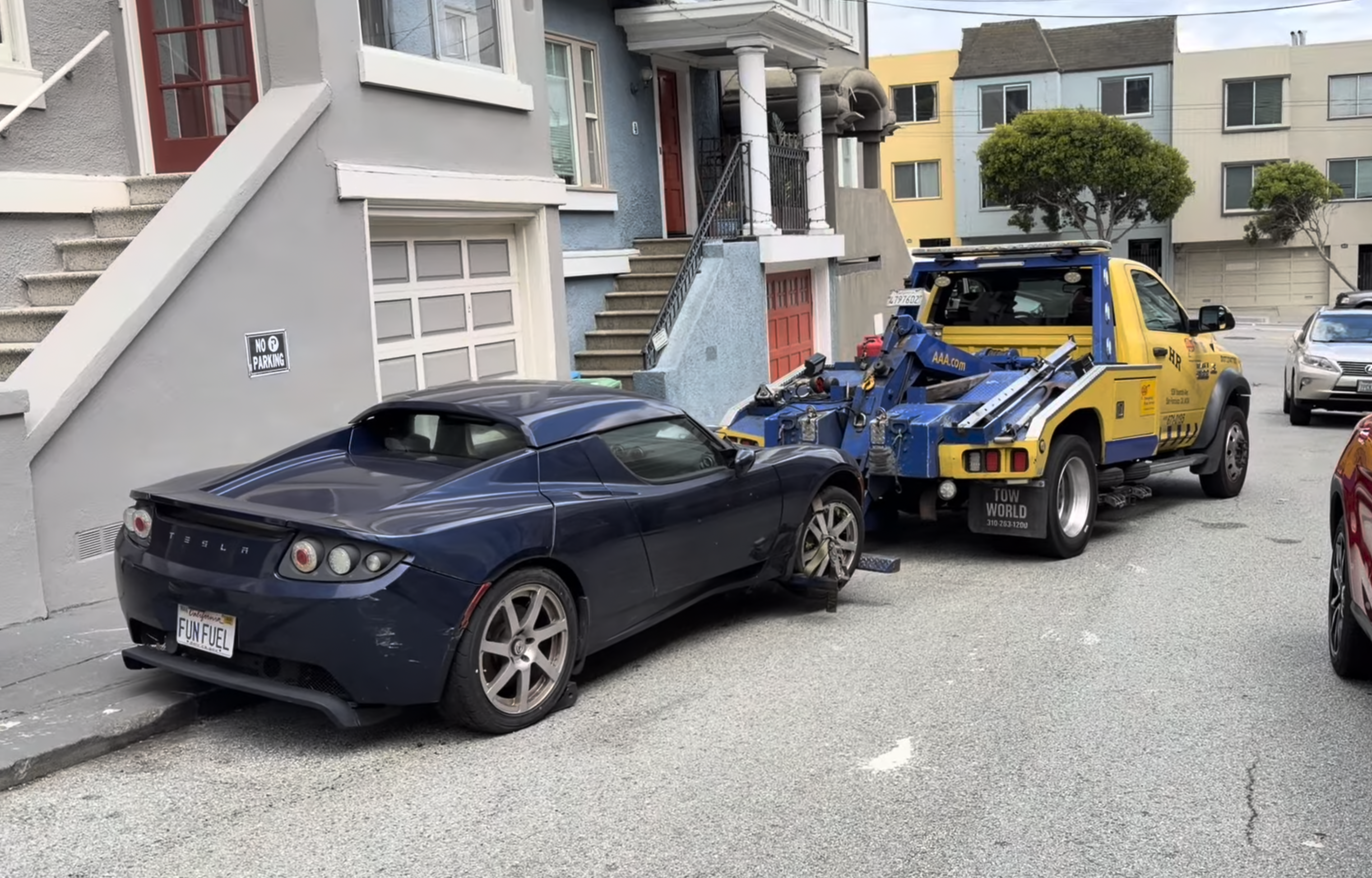 The blue Tesla Roadster being towed from a San Francisco street